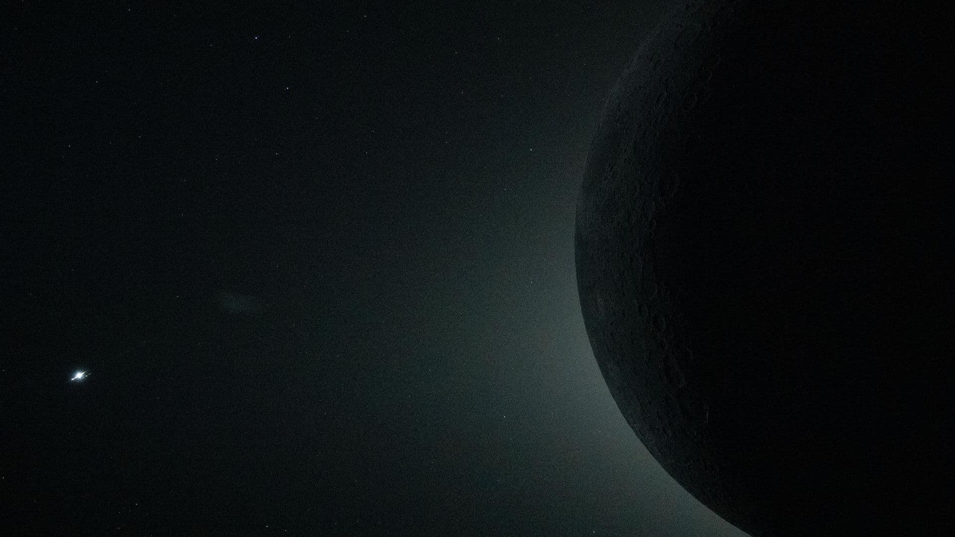 Close-up view from Orion spacecraft during the lunar flyby on April 6 captures a total solar eclipse, with only part of the moon visible as it obscures the sun. The object at left is Venus.